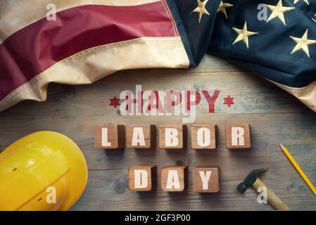 Happy labor day printed on wooden blocks with vintage American flag Stock Photo