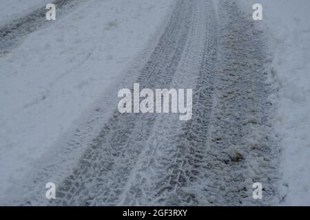 snow-covered curved road close-up across winter landscape, forest. Transportation. Winter weather Stock Photo