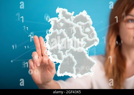 Female's hand touching a floating 3D map of Germany Stock Photo