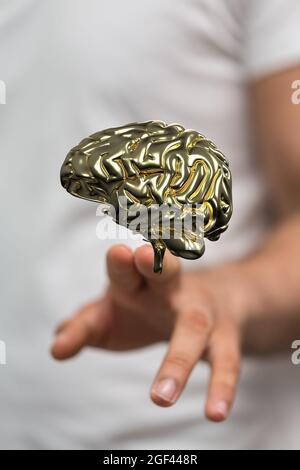 Vertical shot of a hand touching a floating 3D human brain icon above Stock Photo