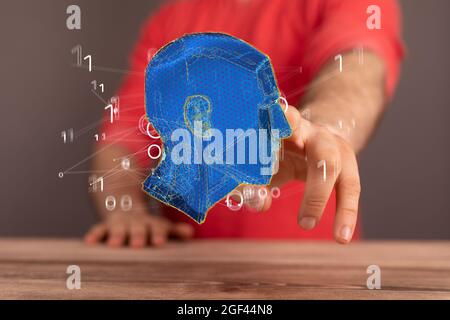 Hand touching a 3D floating human head - artificial intelligence concept Stock Photo
