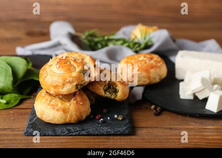 Puff pastry stuffed with spinach on table Stock Photo