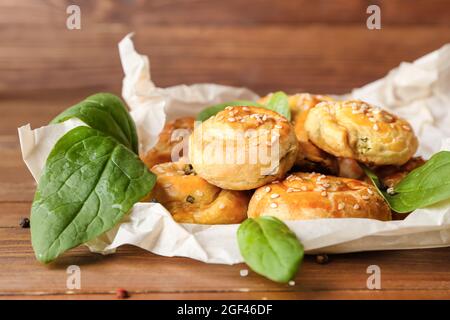 Puff pastry stuffed with spinach on table Stock Photo