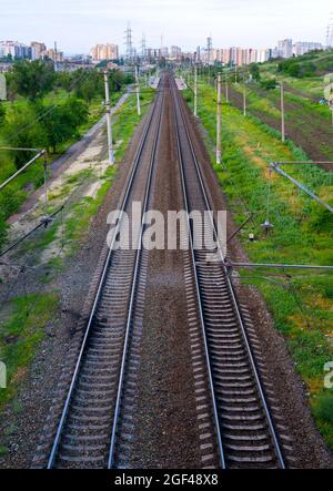 Parallel railway tracks recede into the distance in Volgograd city Stock Photo