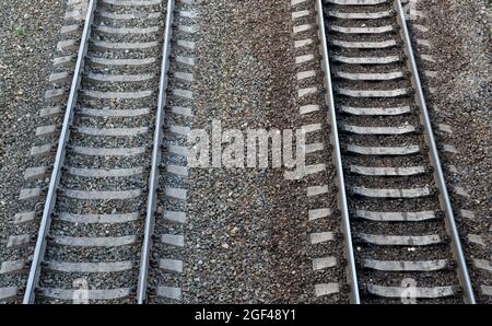 Two parallel railway tracks recede into the distance Stock Photo