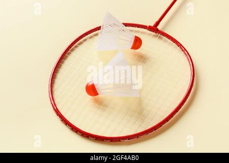 Badminton racket and shuttlecocks on color background Stock Photo