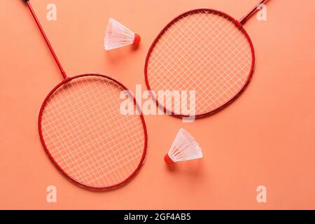 Badminton rackets and shuttlecocks on color background Stock Photo