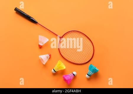 Badminton racket and shuttlecocks on color background Stock Photo