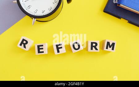 REFORM word written on wooden cubes, Business concept Stock Photo