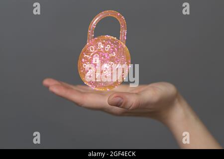Man holding the virtual 3D padlock icon symbolizing data security isolated on a gray background Stock Photo