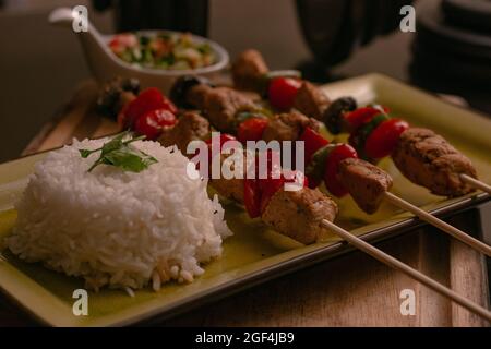 Closeup of delicious Paneer tikka with rice on a track on the table in a restaurant Stock Photo