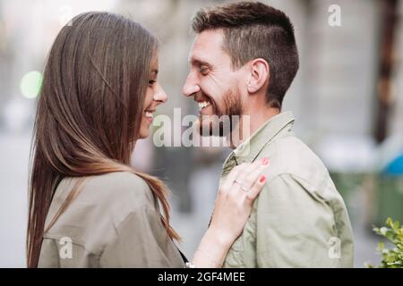 Man smiling while looking at girlfriend Stock Photo