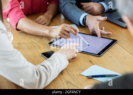 Colleagues using digital tablet while working together at office Stock Photo