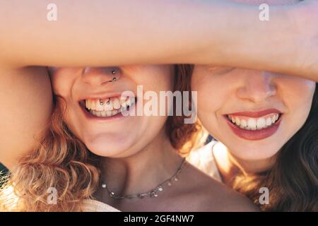 Happy young female friends covering eyes Stock Photo