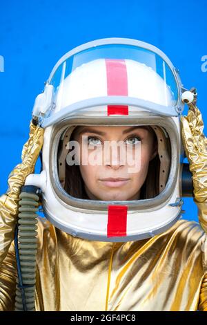 Woman in astronaut costume wearing space helmet Stock Photo