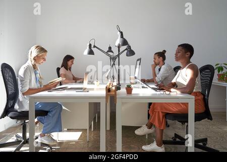 Male and female professionals working at desk in office Stock Photo