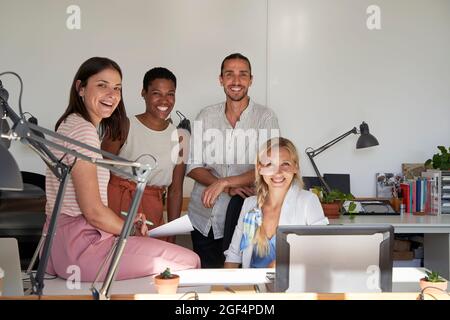 Happy male and female professionals at office Stock Photo