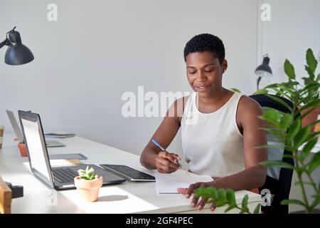 Businesswoman doing paperwork at office Stock Photo