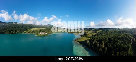 Austria, Salzburg, Hof bei Salzburg, Drone panorama of Lake Fuschl in summer with Schloss Fuschl in background Stock Photo
