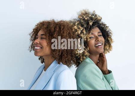 Smiling female professionals standing by white background Stock Photo