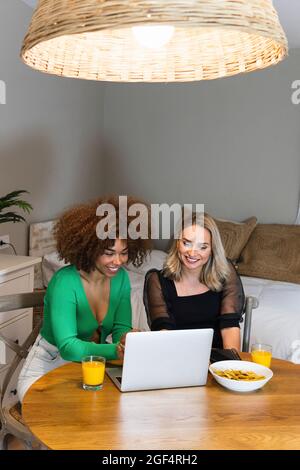 Multi-ethnic female coworkers using laptop at home office Stock Photo