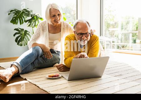Mature couple using laptop at home Stock Photo