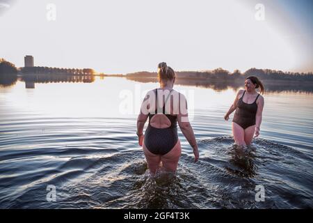 Female friends enjoying water in the morning Stock Photo