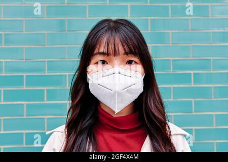 Young woman wearing protective face mask Stock Photo