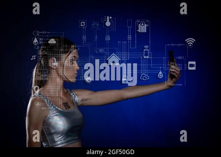 Young woman using phone with virtual icons over blue background Stock Photo