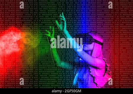 Young woman wearing virtual reality simulator gesturing over colored background Stock Photo