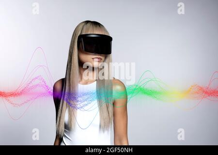 Colorful wave pattern on blond woman wearing black visor glasses against white background Stock Photo