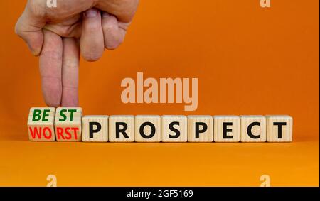 Best or worst prospect symbol. Businessman turns wooden cubes and changes words 'worst prospect' to 'best prospect'. Beautiful orange background. Busi Stock Photo