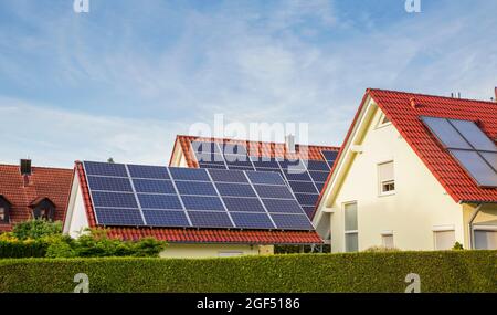 Suburb houses with tiled roofs and solar panels Stock Photo