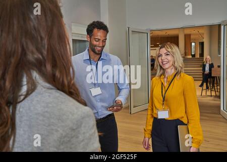 Male and female colleagues discussing in office Stock Photo