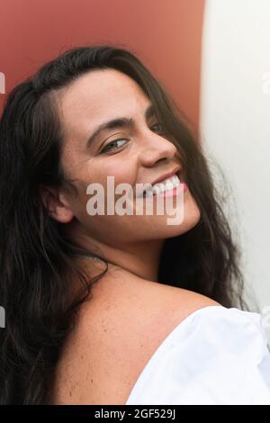 Smiling young woman with long black hair Stock Photo
