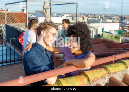 Cheerful multi-ethnic friends standing together on terrace Stock Photo