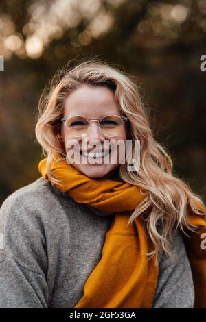 Smiling beautiful blond woman wearing shawl Stock Photo