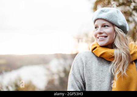Smiling beautiful woman wearing beret and shawl Stock Photo