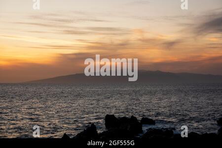 Beautiful Sunset in Playa de San Juan coast, with view on the La Gomera Island, Tenerife, Canary Island, Spain Stock Photo