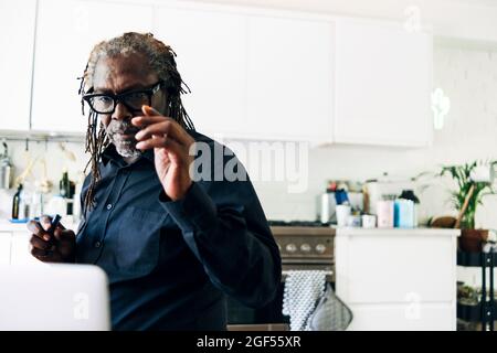 Senior businessman working at home Stock Photo
