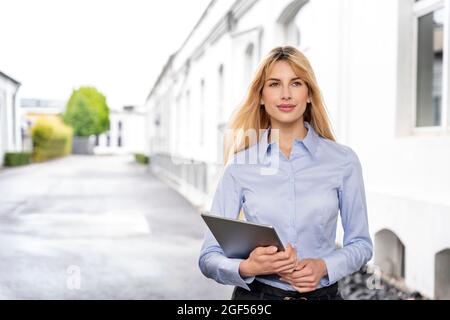 Female professional holding digital tablet Stock Photo