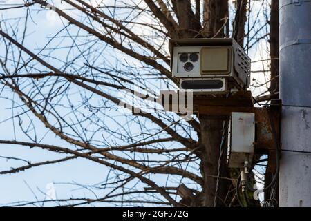 Speed radar camera detector mounted on the pole front closeup telephoto view. Stock Photo