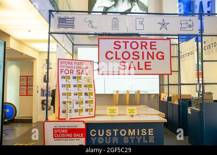 Store Closing Sale signs showing fixtures and fittings for sale at GAP London Oxford Street Flagship Store near to Bond Street - 17 August 2021 Stock Photo