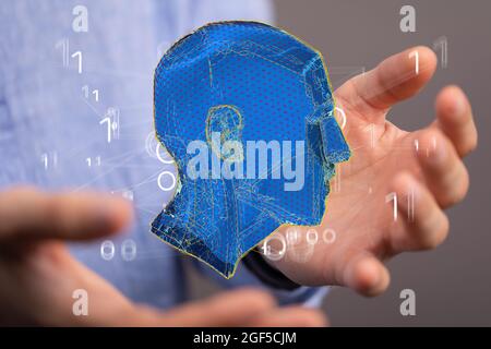 Man holding an abstract polygonal 3D human head Stock Photo