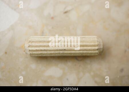 Top view of a wooden pin on a marble surface Stock Photo