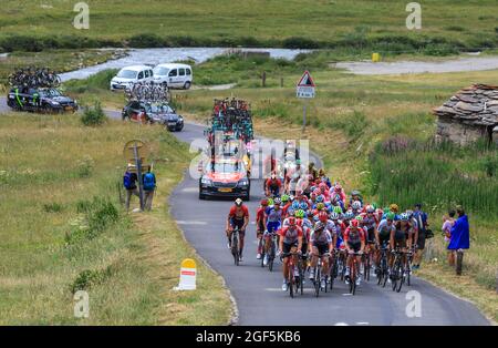 Col de Iseran, France - July 26, 2019: The Peloton climbing the road to Col de Iseran during the stage 19 of Le Tour de France 2019. Stock Photo