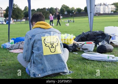 man wears a jean jacket with Animal rebellion logo on its back, South London Greenwich England Stock Photo