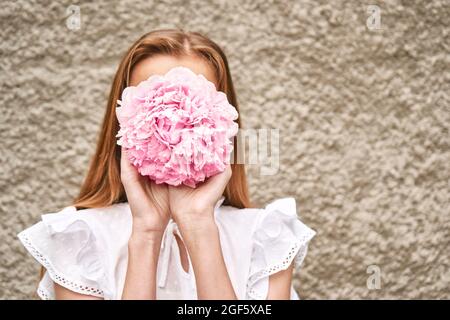 Peony pink bouquet. Female people holding flowers. Faceless lifestyle concept Stock Photo