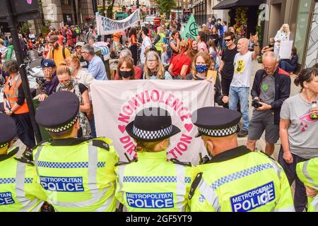 Demonstrators hold a 'Nonviolence Direct Action' banner in front of police officers during the protest in Trafalgar Square. Extinction Rebellion protesters gathered in central London for the start of their two-week campaign entitled Impossible Rebellion, calling on the UK Government to act meaningfully on the ecological and climate crisis. (Photo by Vuk Valcic / SOPA Images/Sipa USA)