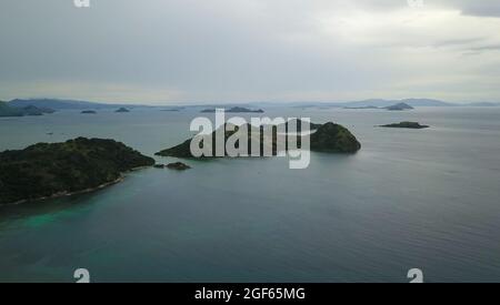 Beautiful aerial view of beaches and tourist boat sailing in Flores Island Indonesia. Stock Photo